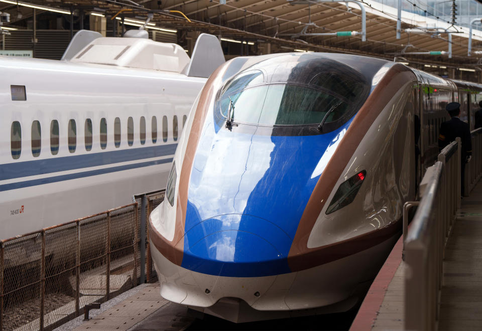 A bullet train Shinkansen stands in the station of Tokyo city