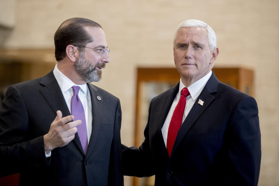 Vice President Mike Pence and Health and Human Services Secretary Alex Azar speak as Pence arrives for a coronavirus task force meeting at the Department of Health and Human Services, Thursday, Feb. 27, 2020, in Washington. (AP Photo/Andrew Harnik)