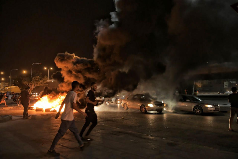 Protesters angry over the area’s crippling electricity shortages, set fire to tires on Thursday, Sept. 10, 2020 in Benghazi, Libya. Libya’s east-based parliament has convened an emergency meeting to address the eruption of rare protests over dire living conditions across the country’s east. Friday's session of the House of Representatives comes after hundreds of young Libyans flooded the streets of Benghazi and other eastern cities. (Hakeam el-Yamany via AP)