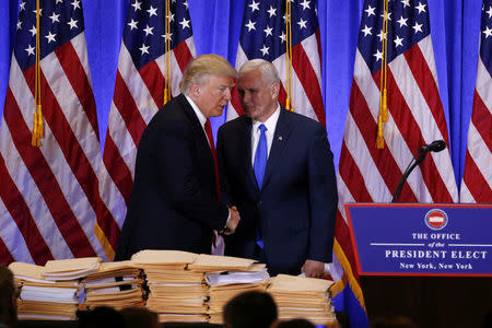 U.S. President-elect Donald Trump greets Vice President-elect Mike Pence during a news conference in the lobby of Trump Tower in Manhattan, New York City, U.S. on January 11, 2017. REUTERS/Lucas Jackson/File Photo