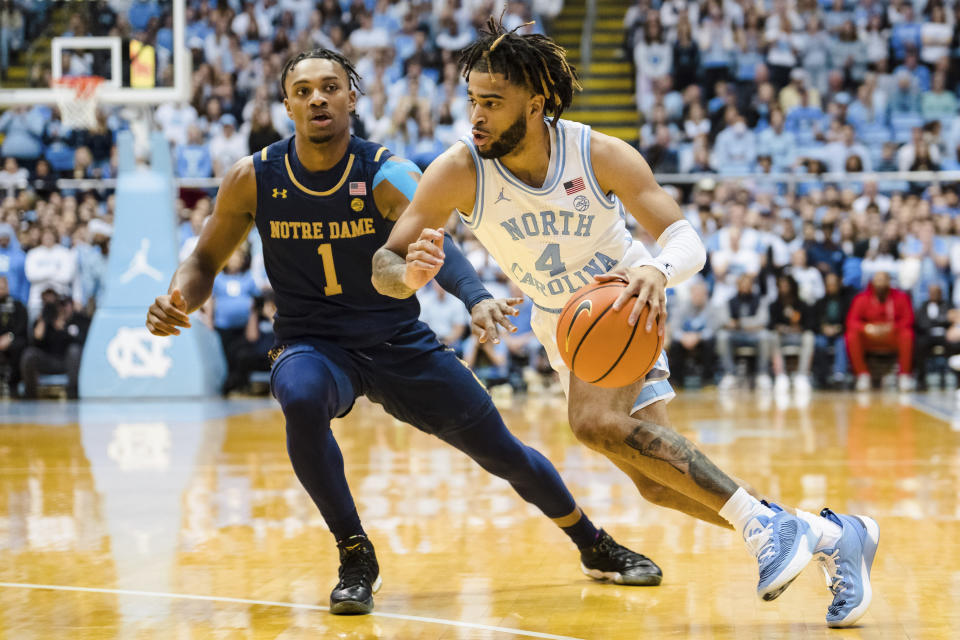 North Carolina guard R.J. Davis (4) drives to the basket while guarded by Notre Dame guard J.J. Starling (1) in the first half of an NCAA college basketball game on Saturday, Jan. 7, 2023, in Chapel Hill, N.C. (AP Photo/Jacob Kupferman)