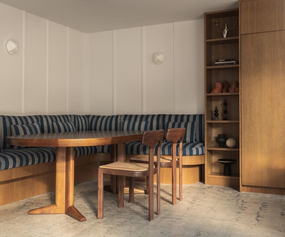 Dining nook with banquette and concrete flooring