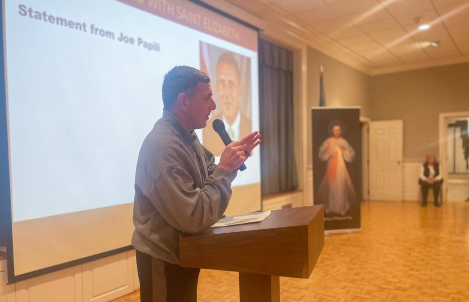 Joseph Papili spoke to nearly 200 people packed a meeting with "We Stand With Saint Elizabeth," a group of concerned parents and parishioners forming after he — president of St. Elizabeth Catholic School — was set to be eliminated, gathering at Cranston Heights Fire Company on Feb. 26, 2024.