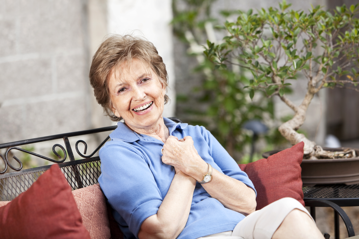 Senior woman sitting on her patio outside