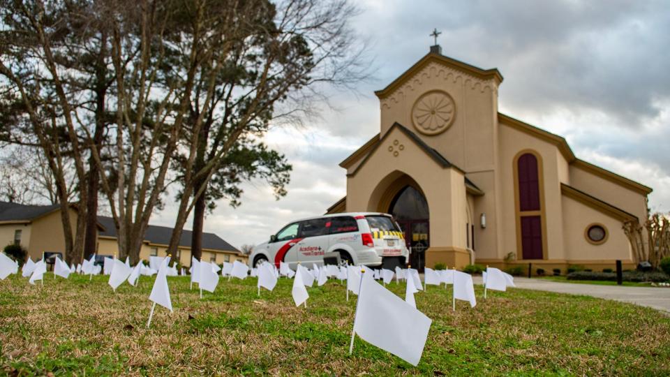 Hundreds of white flags line the lawn of Immaculate Heart of Mary Catholic Church as part of a memorial to people in Lafayette Parish, La., who have died from COVID-19.