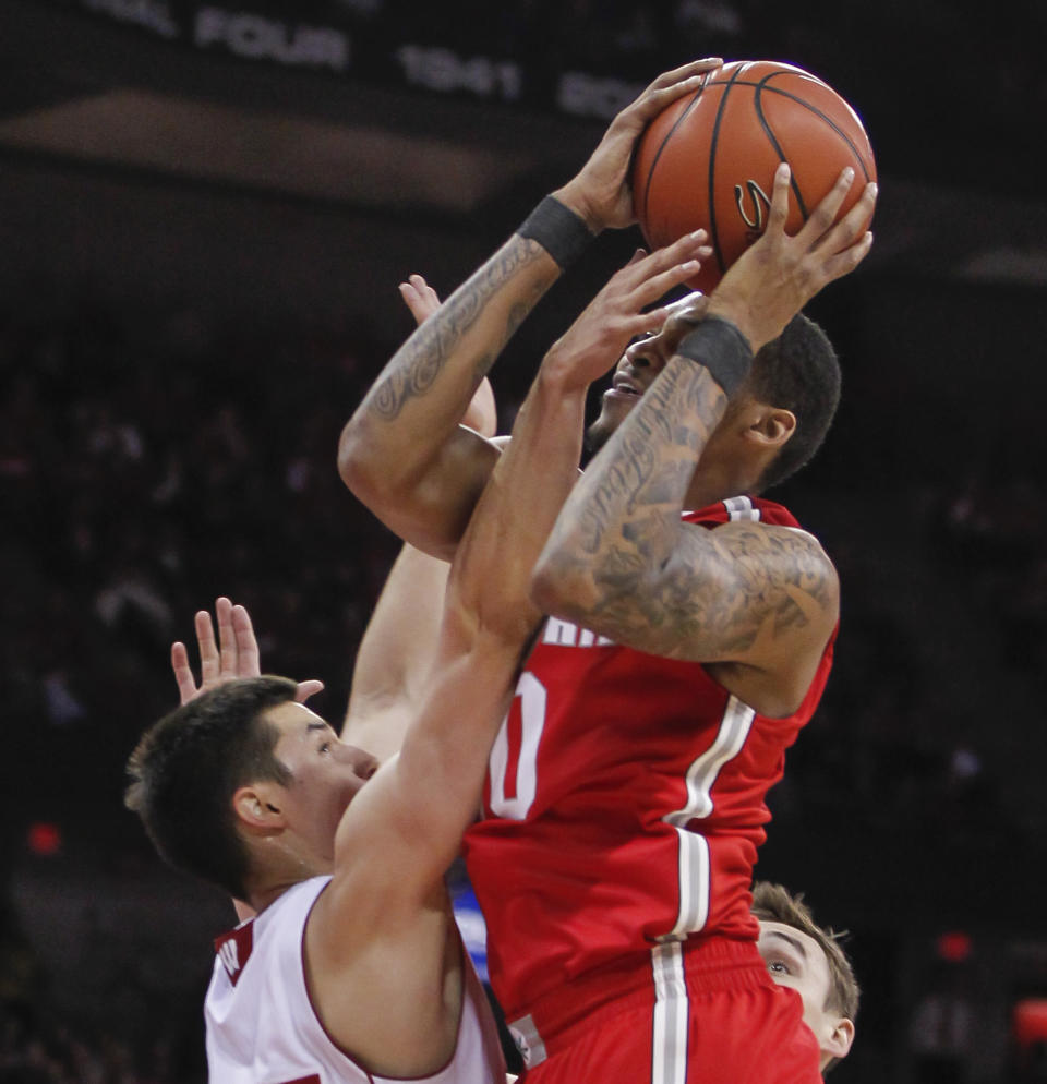 Wisconsin's Bronson Koenig, left, fouls Ohio State's LaQuinton Ross during the first half of an NCAA college basketball game Saturday, Feb. 1, 2014, in Madison, Wis. (AP Photo/Andy Manis)