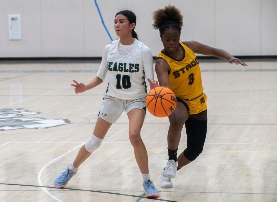 Stagg's Jameelah Pharms, right, attempts to steal the ball from McNair's Aliyah Santos during a SJAA girls varsity basketball game against Stagg at McNair High in Stockton on Feb 1. 2024.