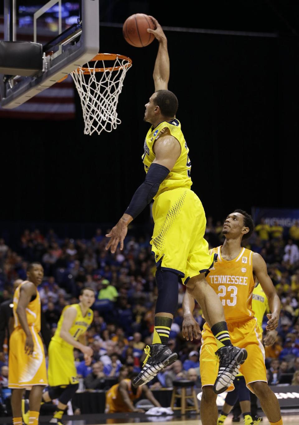 Michigan's Jordan Morgan goes up for a dunk during the first half of an NCAA Midwest Regional semifinal college basketball tournament game against the Tennessee Friday, March 28, 2014, in Indianapolis. (AP Photo/David J. Phillip)