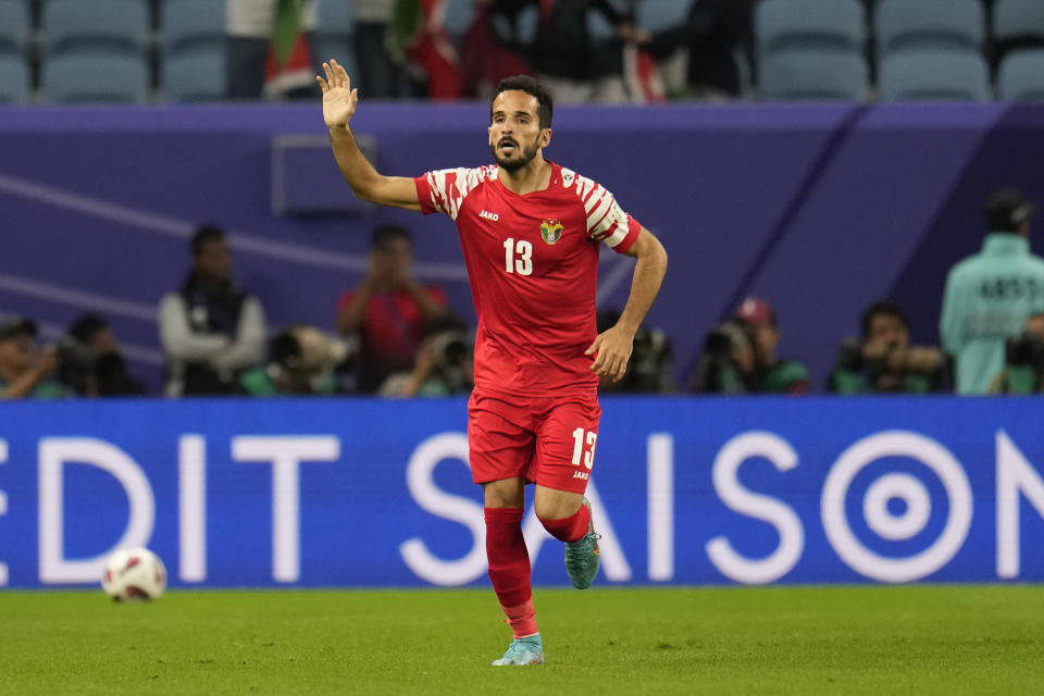 Jordan's Mahmoud Almardi reacts after scoring the opening goal of his team during the Asian Cup Group E soccer match between Malaysia and Jordan at Al Janoub Stadium in Al Wakrah, Qatar, Monday, Jan. 15, 2024. (AP Photo/Aijaz Rahi)