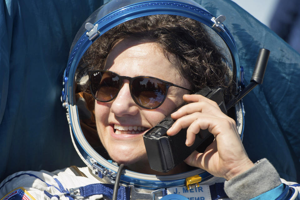 In this handout photo released by Gagarin Cosmonaut Training Centre (GCTC), Roscosmos space agency, U.S. astronaut Jessica Meir speaks phone with her relatives shortly after the landing of the Russian Soyuz MS-15 space capsule near Kazakh town of Dzhezkazgan, Kazakhstan, Friday, April 17, 2020. An International Space Station crew has landed safely after more than 200 days in space. The Soyuz capsule carrying NASA astronauts Andrew Morgan, Jessica Meir and Russian space agency Roscosmos' Oleg Skripochka touched down on Friday on the steppes of Kazakhstan. (Andrey Shelepin, Gagarin Cosmonaut Training Centre (GCTC), Roscosmos space agency, via AP)