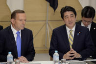 Australian listens to his Japanese counterpart Shinzo Abe at the start of a National Security Council meeting at the latter's official residence in Tokyo Monday, April 7, 2014. It is the first time that a foreign leader attends to the meeting. Abbott is currently on a four-day official visit in Japan. (AP Photo/Franck Robichon, Pool)