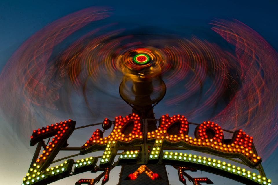 The Zipper ride is a blur at night on the carnival midway at the San Joaquin County Fair in Stockton. Shot with one exposure of 2.5 seconds.