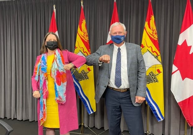 Blaine Higgs and Dr. Jennifer Russell pose for a celebratory picture taken by Higgs' chief of staff Louis Leger following an announcement July 23 that New Brunswick would be lifting COVID-19 restrictions earlier than planned. (Twitter.com - image credit)