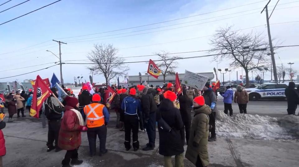 Supporters and members of the Public Service Alliance of Canada rally outside a military office in Ottawa on Feb. 7, 2024.