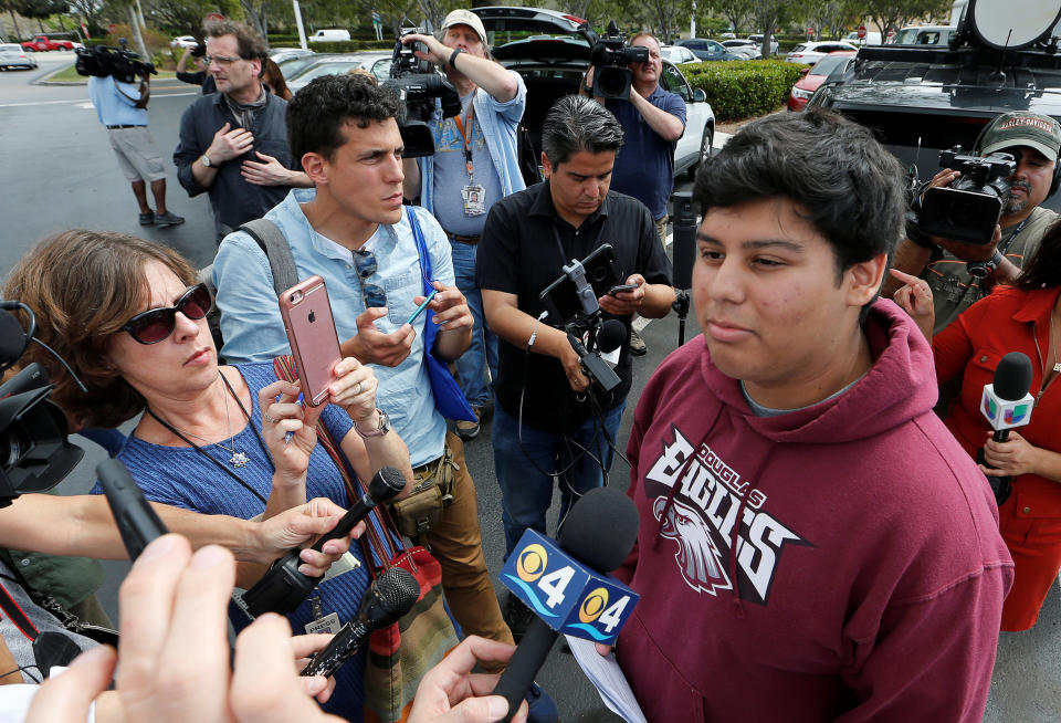 Marjory Stoneman Douglas High School student Jose Iglesias is questioned by reporters Tuesday before joining other students on buses to travel to Tallahassee, Florida, to meet with legislators. (Photo: Joe Skipper/Reuters)