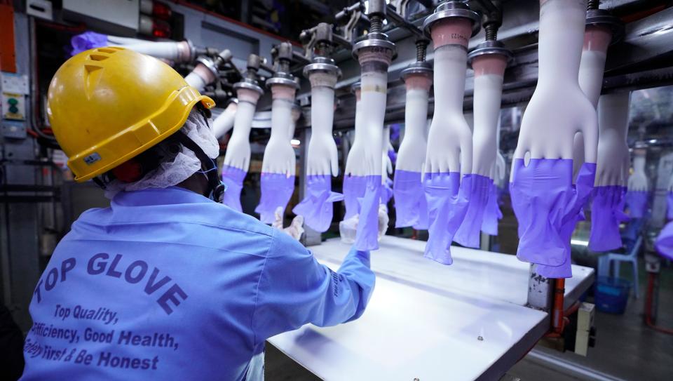 In this Aug. 26 file photo, a worker inspects disposable gloves at the Top Glove factory in Shah Alam on the outskirts of Kuala Lumpur, Malaysia. (Photo: ASSOCIATED PRESS)
