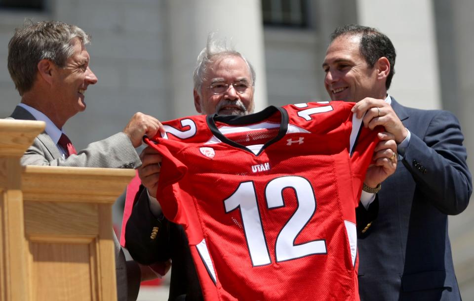 Utah athletics director Chris Hill, left, University of Utah Interim President Lorris Betz, center, and Pac-12 commissioner Larry Scott hold up a Pac-12 Day jersey during Pac-12 Celebration Day at the State Capitol in Salt Lake City on Friday, July 1, 2011. | Kristin Murphy, Deseret News