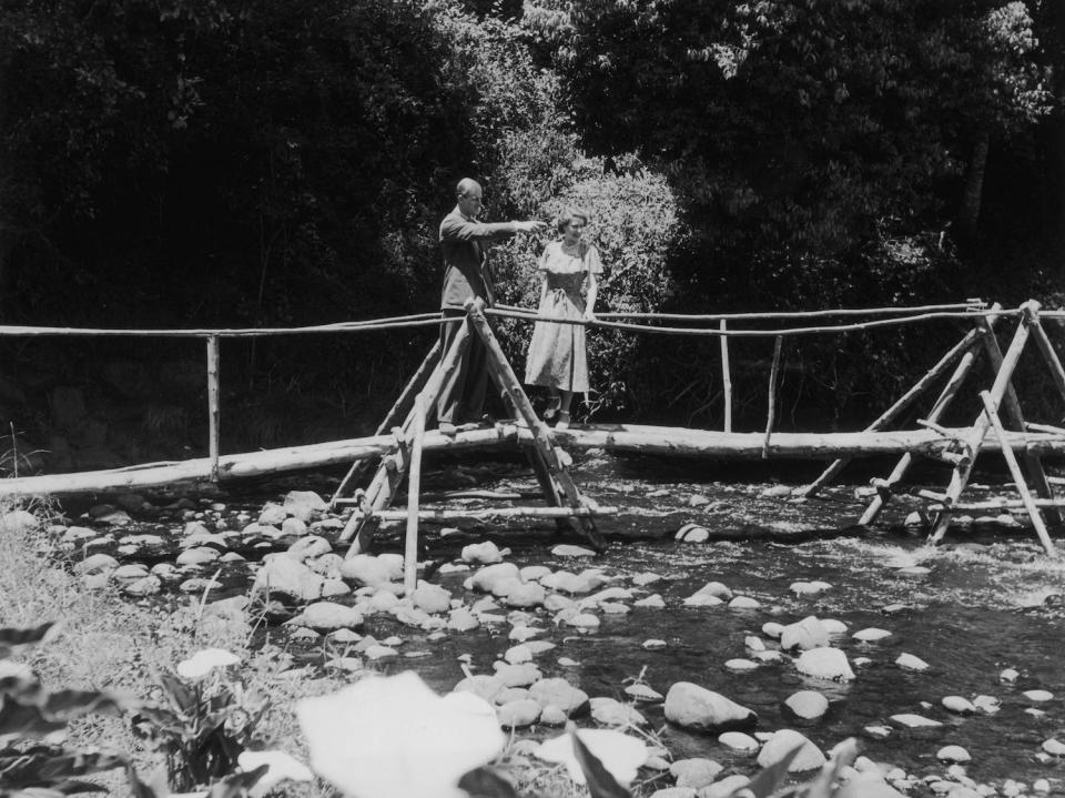 Princess Elizabeth and the Duke of Edinburgh admiring the view from a bridge in Kenya. The following day, news would arrive of the death of King George VI and Elizabeth's accession to the throne.