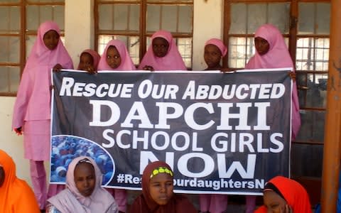 Schoolgirls wait for the arrival of Nigeria's President Muhammadu Buhari at the Goverment girls' science and technical college in Dapchi, Nigeria March 14, 2018  - Credit:  REUTERS