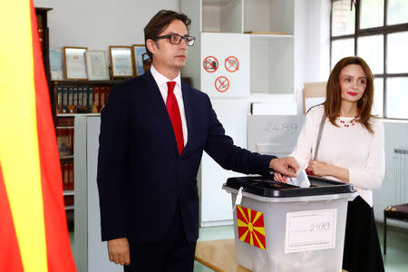 Ruling Social Democratic Union of Macedonia's candidate Stevo Pendarovski and his wife Elizabeta Georgievska cast their ballots during the presidential election in Skopje, North Macedonia May 5, 2019. REUTERS/Ognen Teofilovski