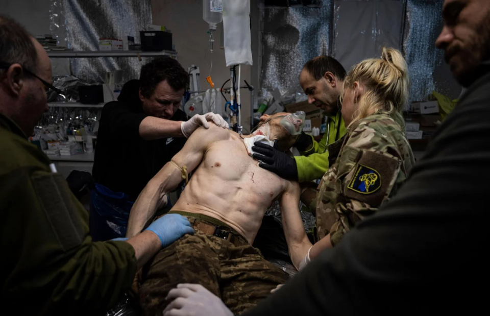 Ukrainian military medics treat a wounded comrade in a field hospital near Bakhmut, Ukraine, February 26 <span class="copyright">Evgeniy Maloletka—AP</span>