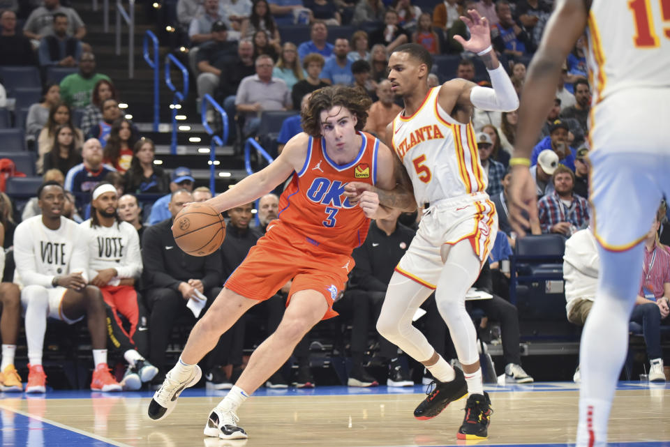 Oklahoma City Thunder guard Josh Giddey (3) pushes past Atlanta Hawks guard Dejounte Murray (5) in the second half of an NBA basketball game, Monday, Nov. 6, 2023, in Oklahoma City. (AP Photo/Kyle Phillips)