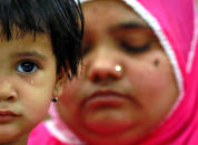 <p>Aksha Yakub Rasool, 2, sits on her mother Bilkis Bano’s (R) knee during a press conference in New Delhi, India May 8, 2017. Bilkis was gang raped and fourteen of her relatives, including her three-year-old daughter, were killed during religious riots that broke out in Gujarat in 2002. Last week a court in Mumbai upheld the conviction of 11 men to life in prison for the rape and murder. (Cathal McNaughton/Reuters) </p>