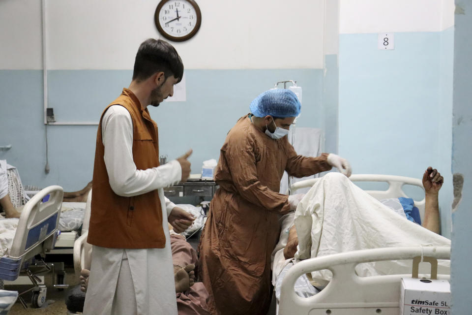 A victim receives medical assistance in a hospital after he was wounded in the deadly attacks outside the airport in Kabul, Afghanistan, Thursday, Aug. 26, 2021. Two suicide bombers and gunmen attacked crowds of Afghans flocking to Kabul's airport Thursday, transforming a scene of desperation into one of horror in the waning days of an airlift for those fleeing the Taliban takeover. (AP Photo/Khwaja Tawfiq Sediqi)