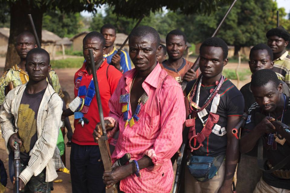 Militia fighters known as anti-balaka pose for a photograph in Mbakate village, Central African Republic November 25, 2013. The group say they are protecting their village from Seleka fighters. With the country slipping deeper into chaos, former colonial power France plans to boost its force there to around 1,000 troops to restore law and order until a much bigger African Union force fully deploys. The land-locked country has been gripped by violence since the mainly Muslim rebels, many of them fighters from neighbouring Sudan and Chad, seized power in the majority Christian country in March. Some 460,000 people - around a tenth of the population - have fled the sectarian violence their takeover ignited. Picture taken November 25, 2013. REUTERS/Joe Penney (CENTRAL AFRICAN REPUBLIC - Tags: CIVIL UNREST SOCIETY POLITICS TPX IMAGES OF THE DAY) ATTENTION EDITORS: PICTURE 22 OF 31 FOR PACKAGE 'TURMOIL IN CENTRAL AFRICAN REPUBLIC' TO FIND ALL IMAGES SEARCH 'PENNEY TURMOIL'