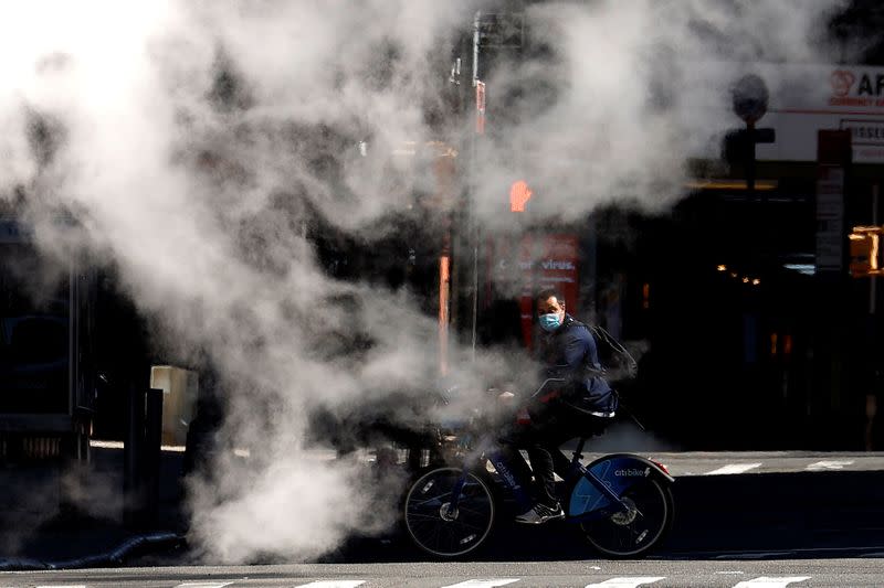 A man crosses 7th Avenue in nearly deserted Times Square during the outbreak of the coronavirus disease (COVID-19) in New York