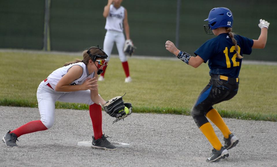 Bedford shortstop Maddy Kwiatkowski waits to place the tag on a steal by Macy OÕvall of Whiteford in the 2023 Monroe County Fair Tournament Tuesday, July 9, 2023.