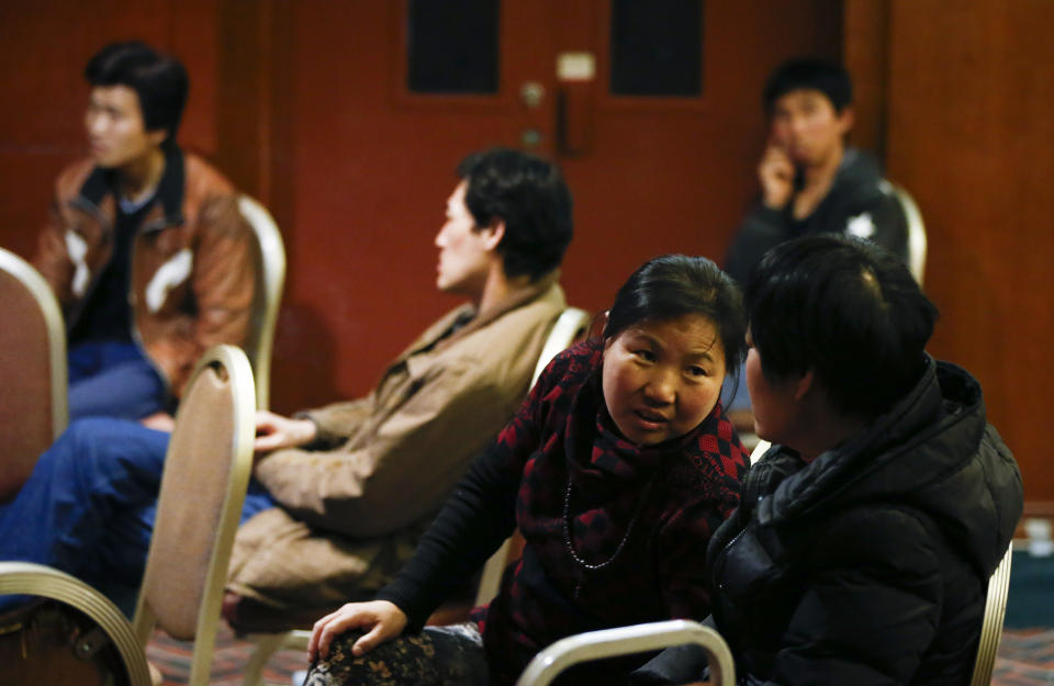 Chinese relatives of passengers aboard a missing Malaysia Airlines plane wait for the latest news at a hotel room in Beijing, China Thursday, March 13, 2014. Planes sent Thursday to search the area where Chinese satellite images showed possible debris from the missing Malaysian jetliner found nothing, Malaysia's civil aviation chief said, deflating the latest lead in the six-day hunt. (AP Photo/Vincent Thian)