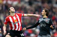 <p>John O’Shea (left) looks to clear from Manolo Gabbiadini</p>