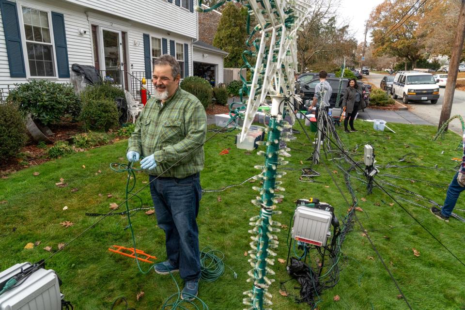 Everett Lewis directs family and volunteers on the first day of the 2023 Christmas light show set-up at his home in Warwick.