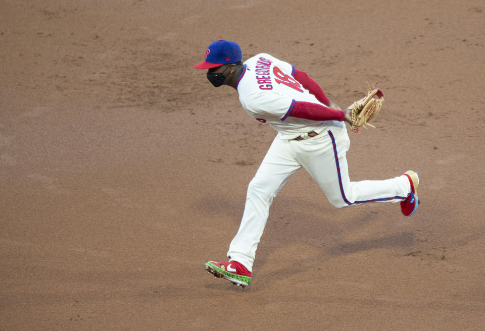 Philadelphia Phillies shortstop Didi Gregorius (18) chases a base hit by the Toronto Blue Jays' Teoscar Hernandez during the first inning of a baseball game, Saturday, Sept. 19, 2020, in Philadelphia. (AP Photo/Laurence Kesterson)