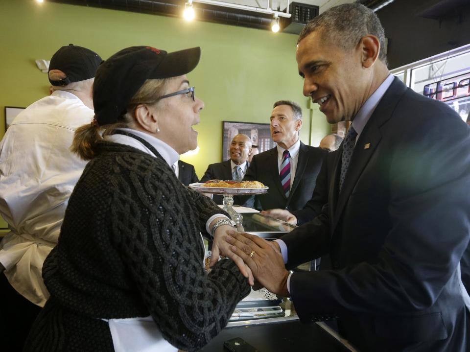 President Barack Obama greets owner Alice Bruno and her husband Rob Chiovoloni, far left, during his unannounced visit to Café Beauregard in New Britain, Conn., Wednesday, March 5, 2014. Also at the counter with Obama are Massachusetts Gov. Deval Patrick, center, and Vermont Gov. Peter Shumlin. Obama traveled to Hartford, Conn., area to highlight the importance of raising the minimum wage and then will travel to Boston for a pair of Democratic fundraising. (AP Photo/Pablo Martinez Monsivais)