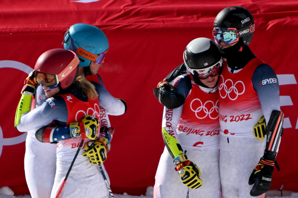 USA skiers (from left) Mikaela Shiffrin, River Radamus, Paula Moltzan and Tommy Ford react after finishing fourth in the mixed team parallel event at the 2022 Winter Olympic Games at the Yanqing National Alpine Skiing Centre in Yanqing on February 20, 2022. (FABRICE COFFRINI/AFP via Getty Images)