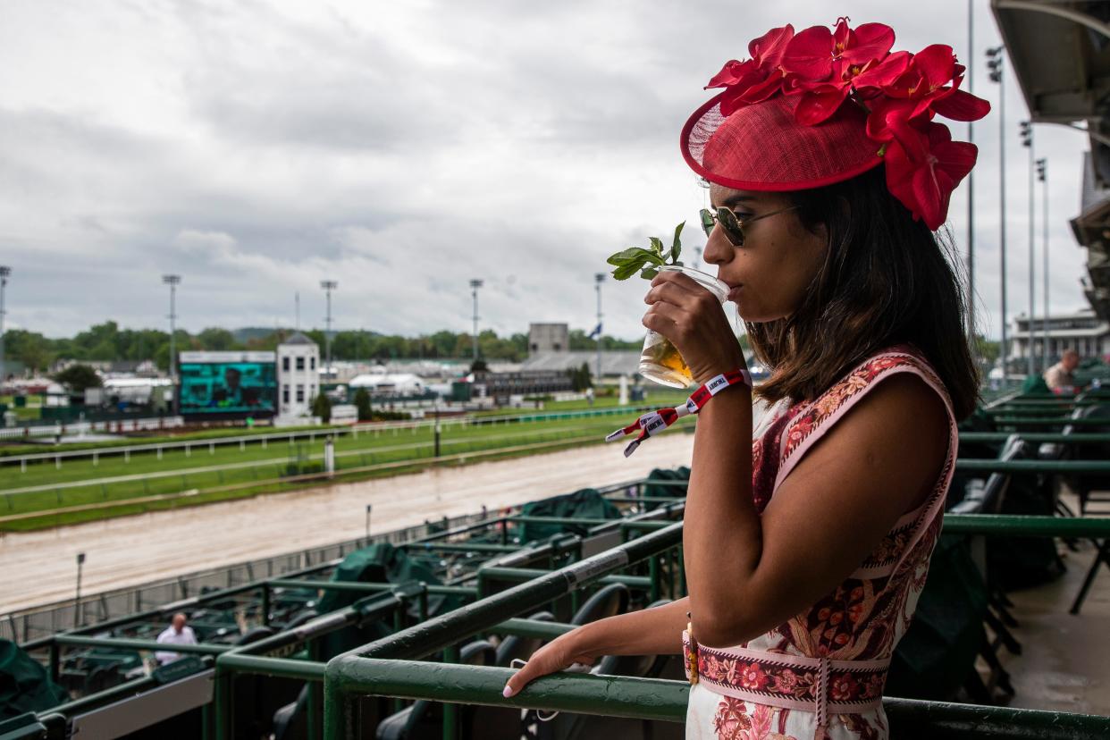 Camila Moscoso sips a mint julep during a rainy Thurby at Churchill Downs. April 29, 2021