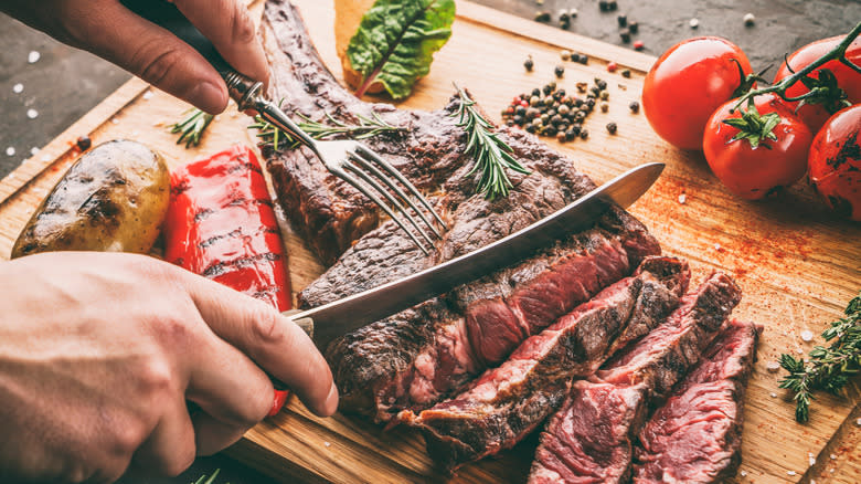 juicy cowboy steak being cut