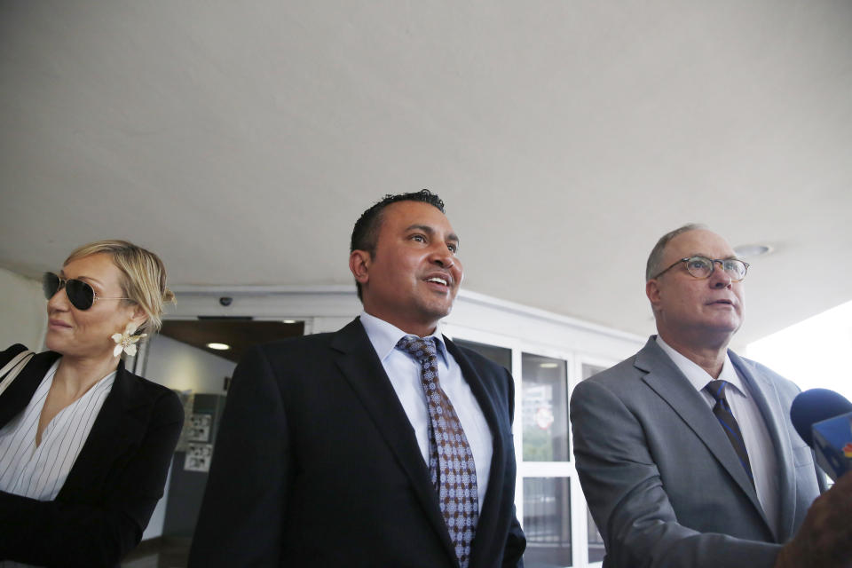 Attorneys for the defendants, Lawrence Hashish, center, David Frankel, right, and paralegal Juliana Marulanda, left, walk into the Broward County Jail on Monday, Aug. 26, 2019, in Fort Lauderdale, Fla. Three people, including two nurses, are surrendering following charges in the case of a Florida nursing home where 12 patients died after losing power went out amid sweltering heat following Hurricane Irma in 2017. (AP Photo/Brynn Anderson)