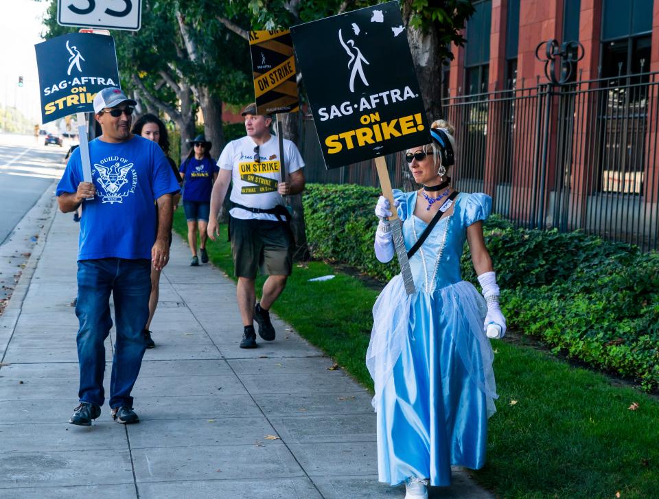 Andrea Calabrese, dressed in a Cinderella costume, joined picketers at Disney Studios on Wednesday.