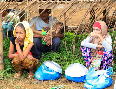 Evacuees with their relief goods take a break, after fleeing to an evacuation centre to avoid the fighting in Marawi between the government troops and Islamic State-linked militants, in Saguiaran town, Lanao Del Sur, southern Philippines September 10, 2017. REUTERS/Romeo Ranoco