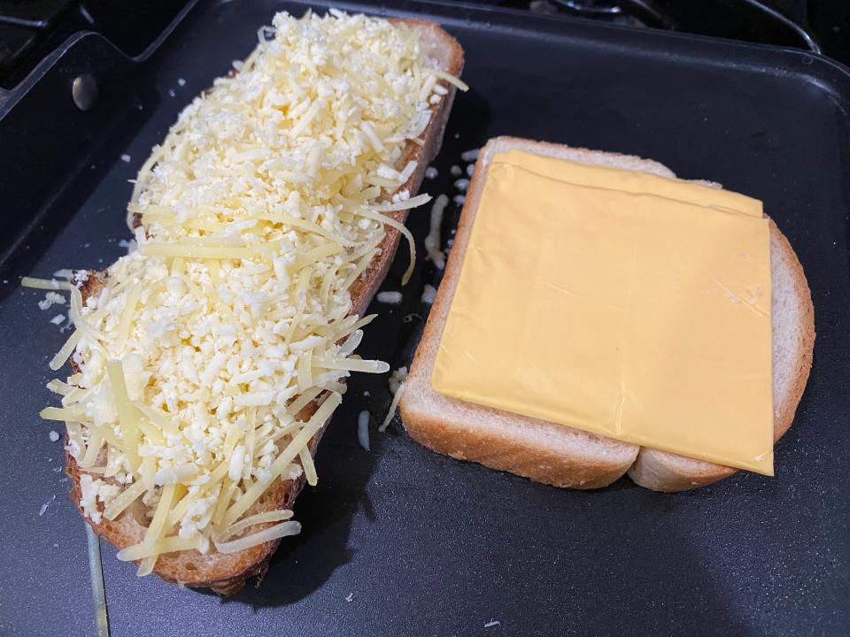 a slide of country loaf with shredded cheese and a slice of white bread with american slices