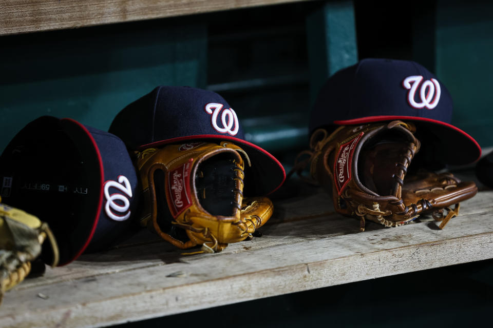 WASHINGTON, DC - AUGUST 15: A general view of Washington Nationals hats and Rawlings gloves in the dugout during the seventh inning of the game between the Washington Nationals and the Boston Red Sox at Nationals Park on August 15, 2023 in Washington, DC. (Photo by Scott Taetsch/Getty Images)