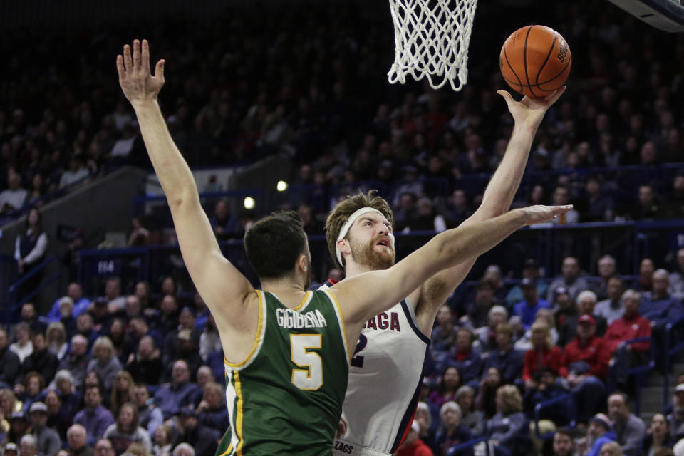 Gonzaga forward Drew Timme, right, shoots while defended by San Francisco center Saba Gigiberia during the first half of an NCAA college basketball game, Thursday, Feb. 9, 2023, in Spokane, Wash. (AP Photo/Young Kwak)