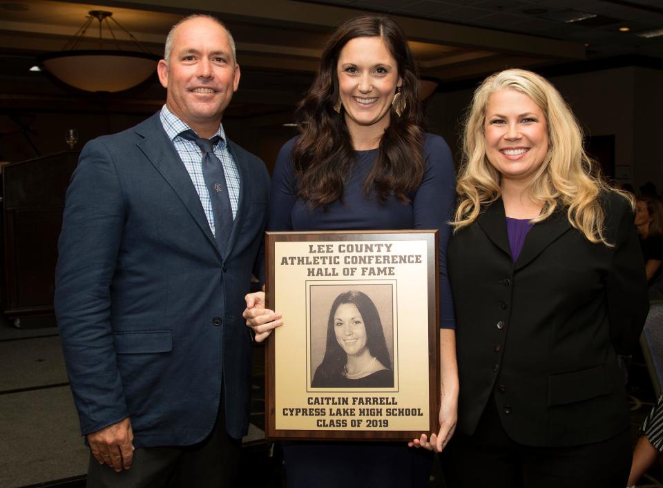 Caitlin Farrell, a 2006 Cypress Lake High School graduate, is inducted into the Lee County Athletic Conference Hall of Fame on Thursday in Fort Myers. Farrell played soccer at Cypress Lake. Farrell's brother, Liam, left, and Cypress Lake principal Angela Roles are among her supporters.