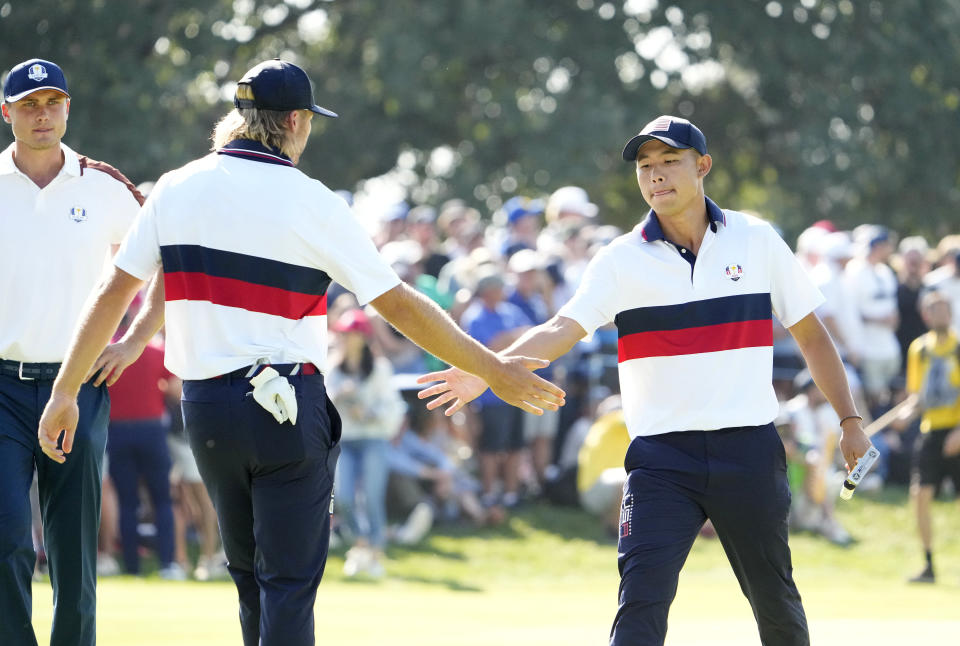 Team USA golfer Sam Burns and Team USA golfer Collin Morikawa celebrate as they walk off the 9th green during day two fourballs round for the 44th Ryder Cup golf competition at Marco Simone Golf and Country Club. Mandatory Credit: Adam Cairns-USA TODAY Sports