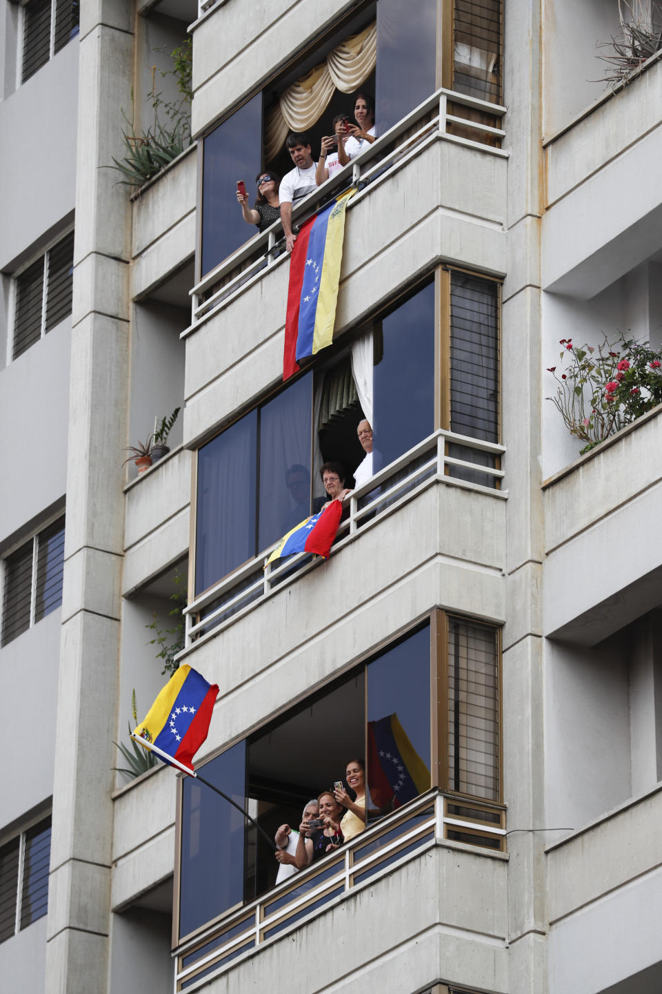 Supporters of Juan Guaido, Venezuela's National Assembly leader who has declared himself the country's interim president, listen to the opposition leader during a rally against the government of President Nicolas Maduro, in Caracas, Venezuela, Saturday, March 9, 2019. (AP Photo/Eduardo Verdugo)