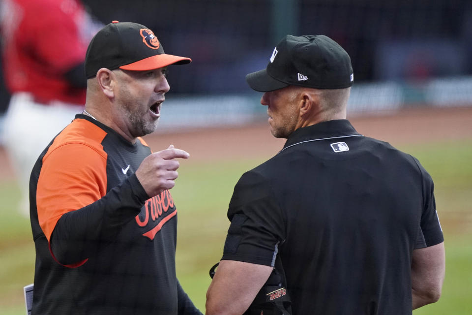 Baltimore Orioles manager Brandon Hyde, left, argues with home plate umpire Jim Wolf in the first inning of a baseball game against the Cleveland Indians, Monday, June 14, 2021, in Cleveland. (AP Photo/Tony Dejak)