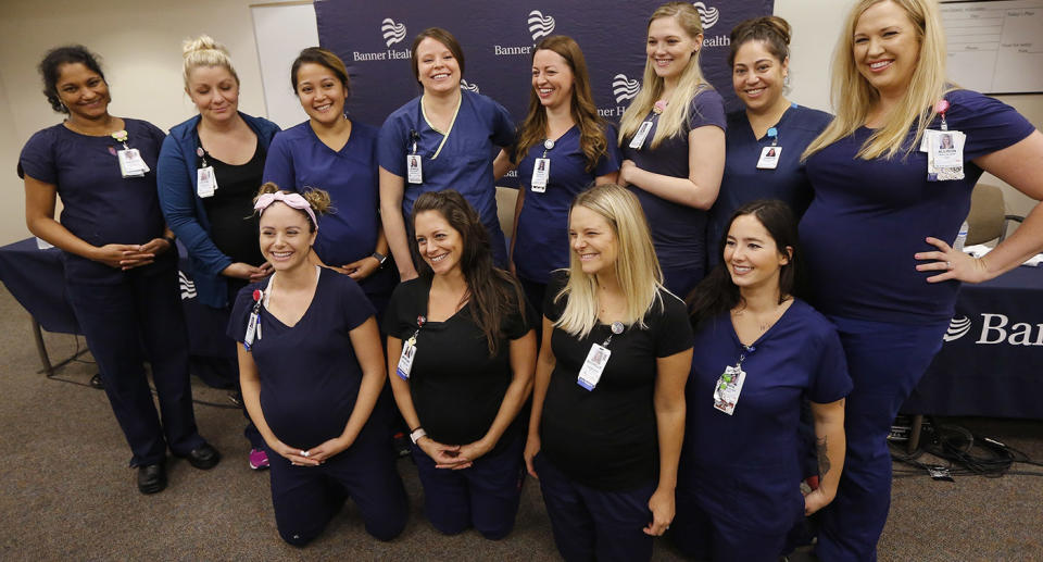 Most of the sixteen pregnant nurses who work together in the intensive care unit at Banner Desert Medical Center pose for a group photograph. Source: AP Photo via AAP